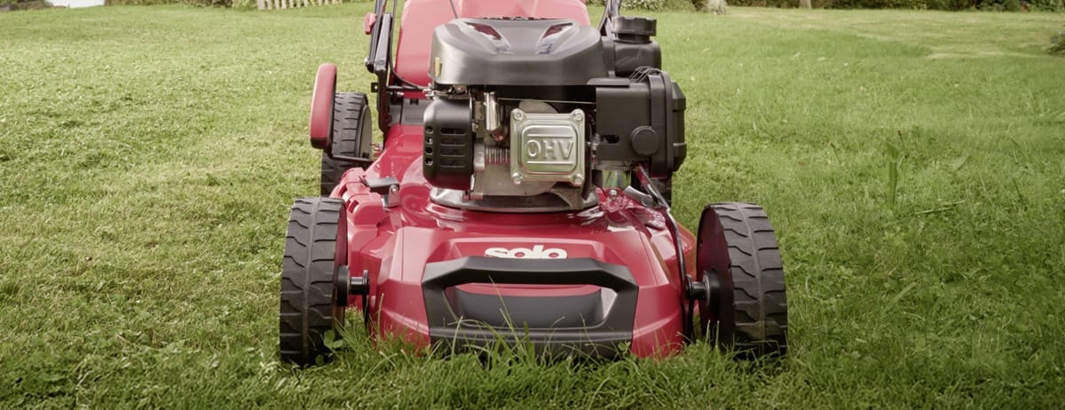 An AL-KO petrol lawnmower on a freshly cut garden lawn